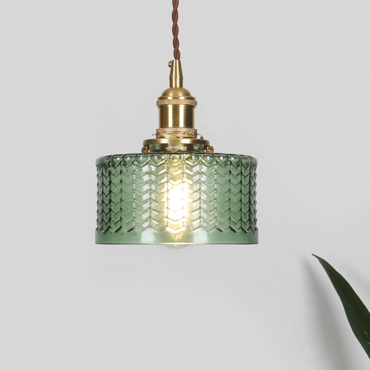 Round glass pendant light with textured shade and brass fitting