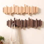 Wall-mounted wooden coat rack with staggered folding hooks