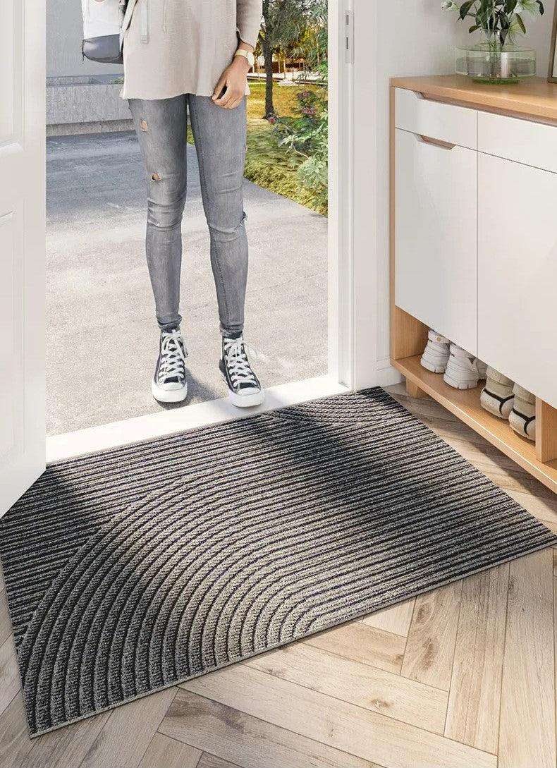 Rectangular ribbed geometric door mat positioned in a home entrance