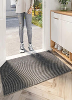 Rectangular ribbed geometric door mat positioned in a home entrance
