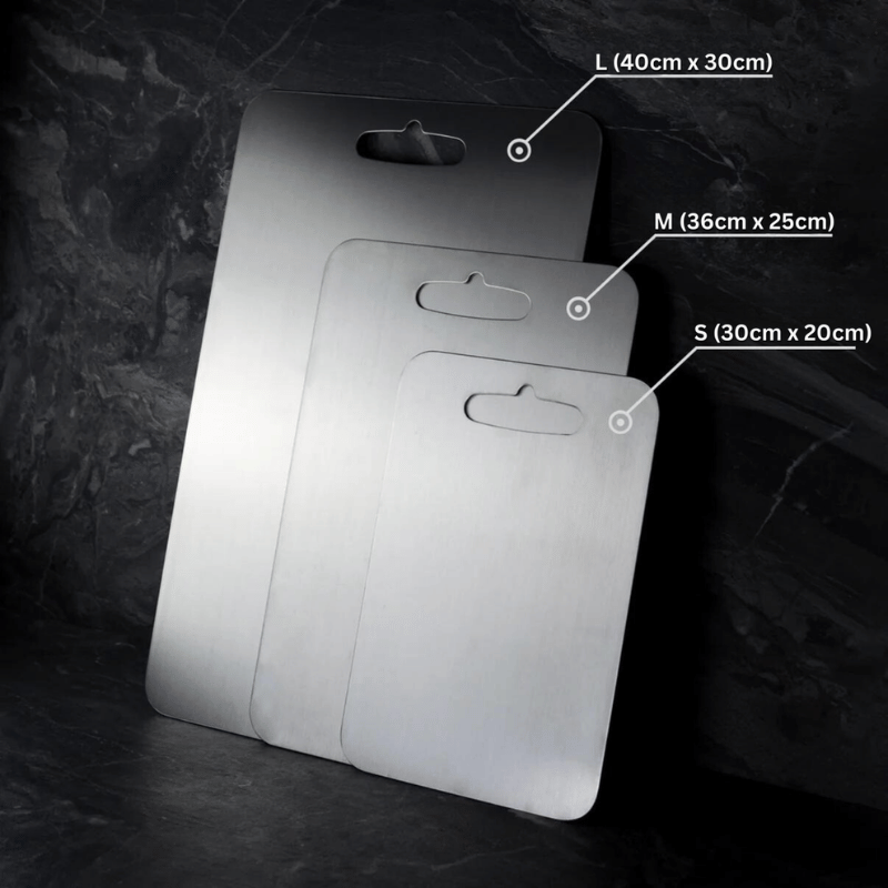 Three grey metal cutting boards with rounded corners and hanging handles