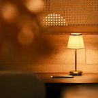 Table lamp with pleated shade, slim stem and round base