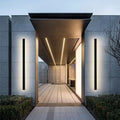 Slim vertical outdoor LED wall light on an exterior entrance wall