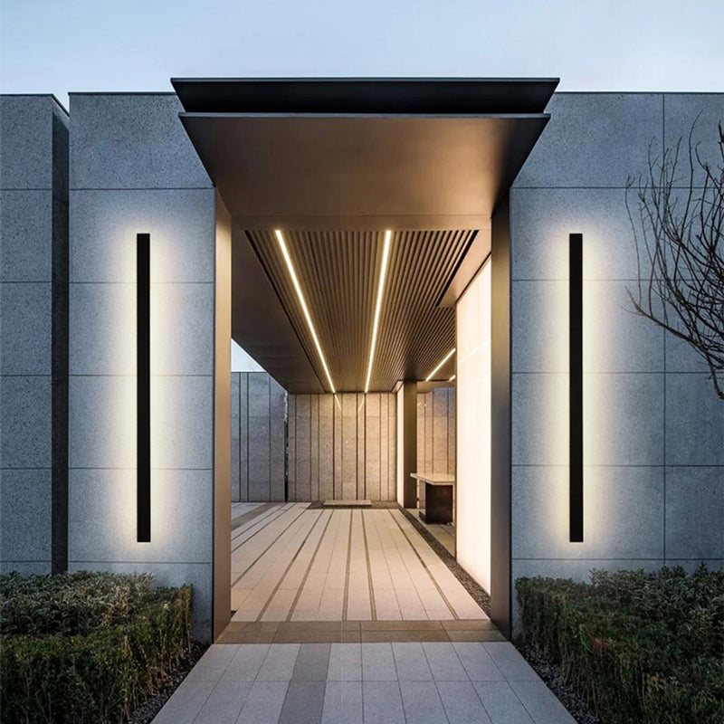 Slim vertical outdoor LED wall light on an exterior entrance wall