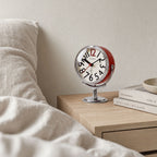 Round analogue alarm clock with bold numerals and raised metallic-effect stand