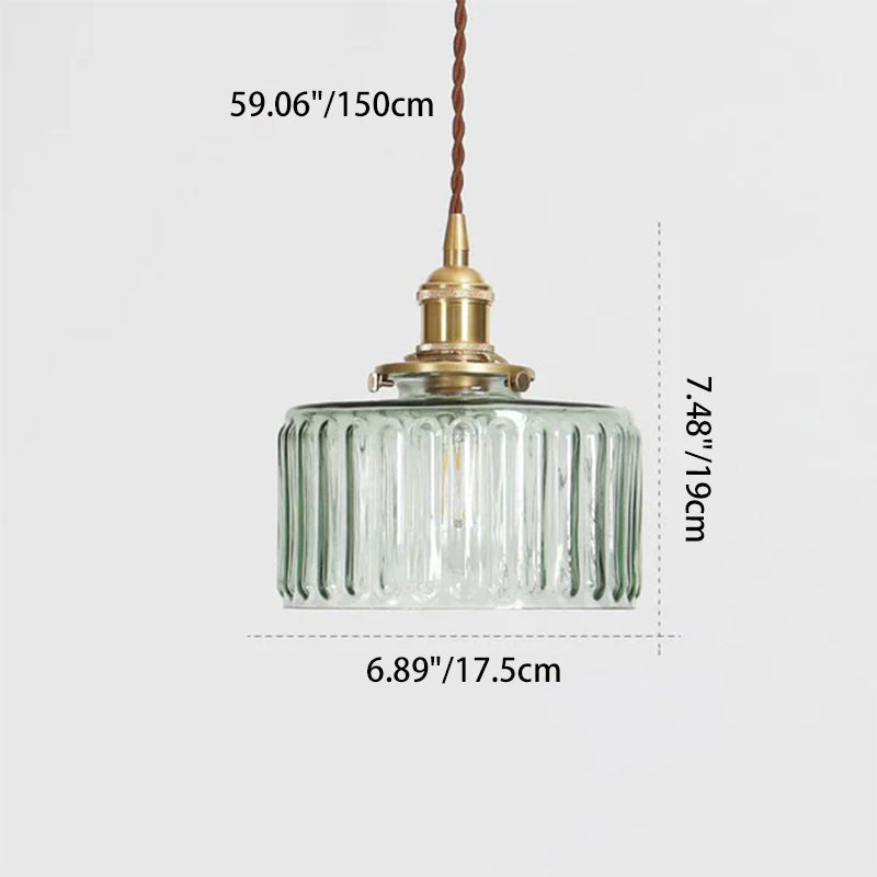 Round glass pendant light with textured shade and brass fitting
