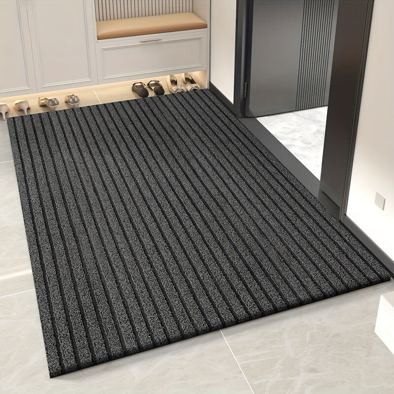 Rectangular ribbed striped doormat with dark edging by an entrance