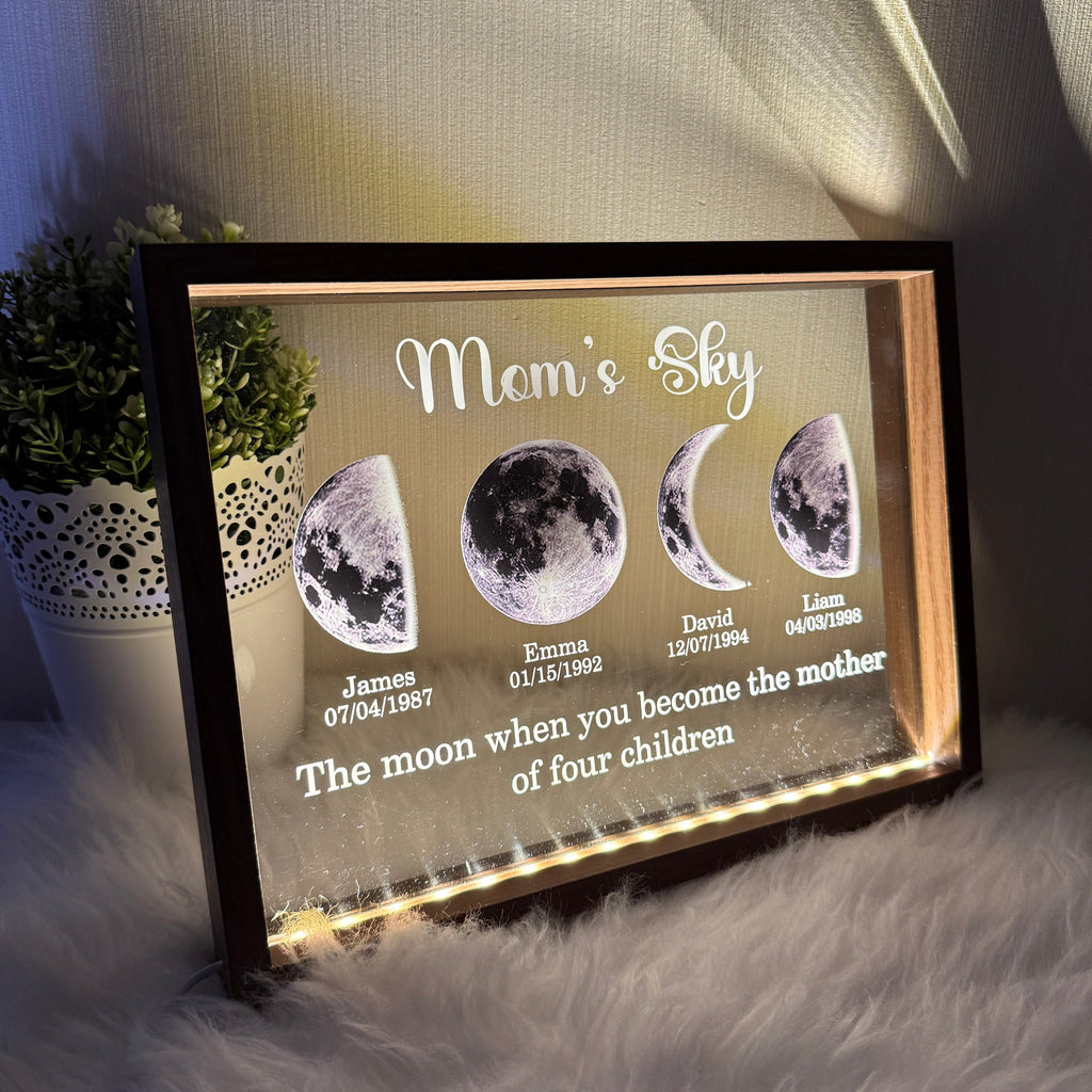 Illuminated black framed moon phase family display with names and dates