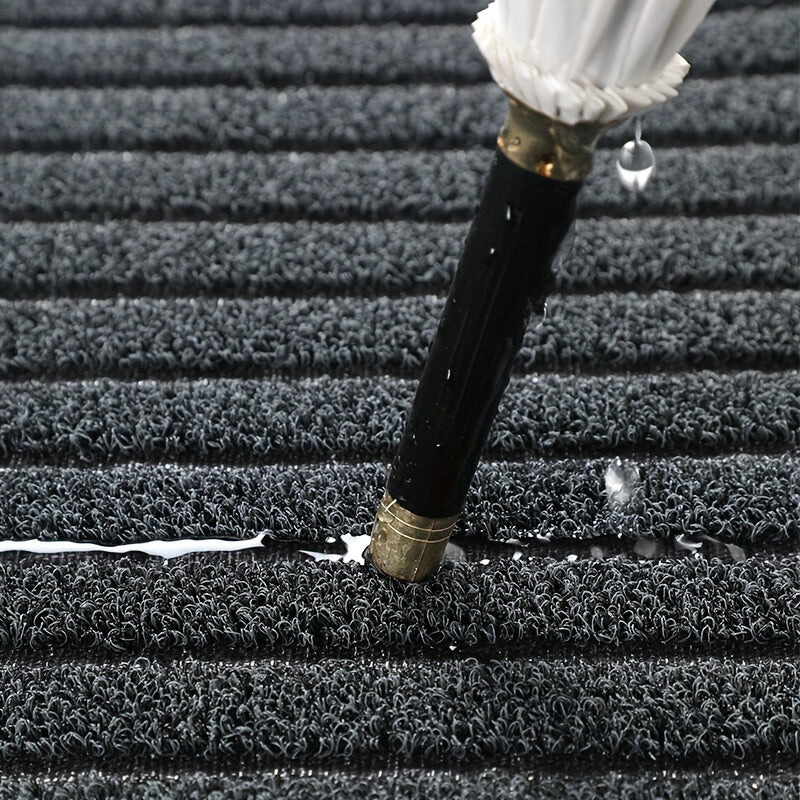 Rectangular ribbed striped doormat with dark edging by an entrance