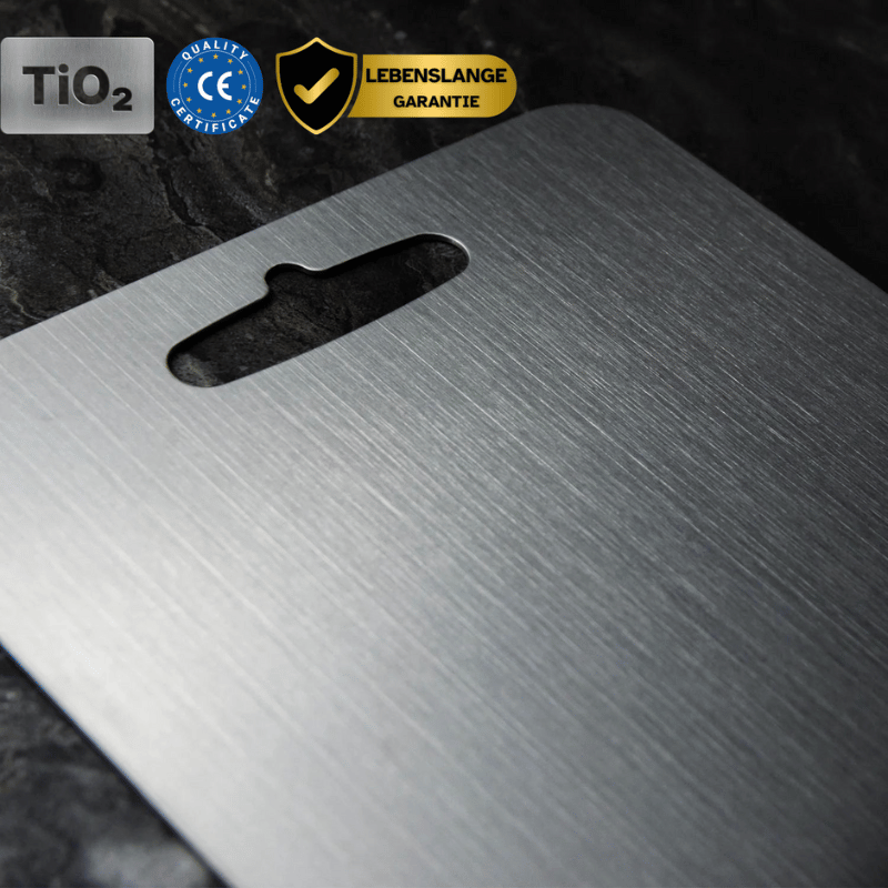 Three grey metal cutting boards with rounded corners and hanging handles