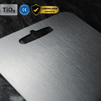 Three grey metal cutting boards with rounded corners and hanging handles