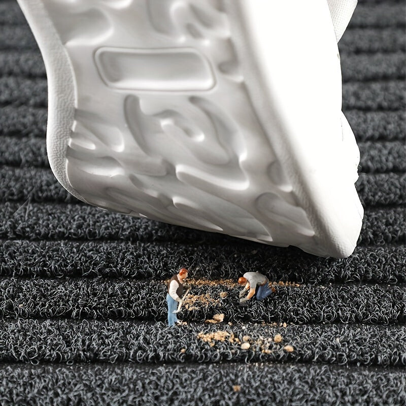 Rectangular ribbed striped doormat with dark edging by an entrance