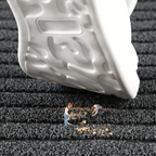 Rectangular ribbed striped doormat with dark edging by an entrance