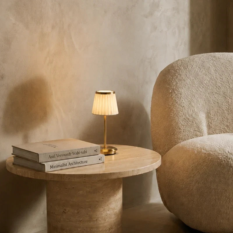 Table lamp with pleated shade, slim stem and round base