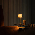 Table lamp with pleated shade, slim stem and round base
