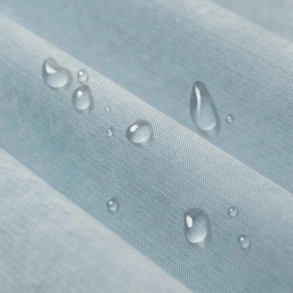 Light blue waterproof sofa cover draped over a sofa