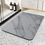 Black rectangular bathroom mat with white marble-effect veining and rounded corners