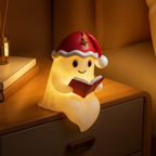 Illuminated beige Christmas ghost decoration wearing a red Santa hat and holding an open book
