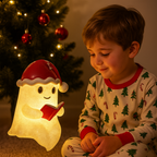 Illuminated beige Christmas ghost decoration wearing a red Santa hat and holding an open book