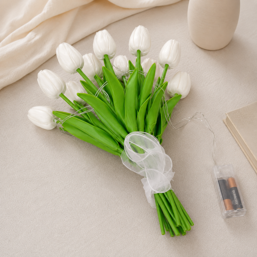 Illuminated tulip flower bouquet with green leaves in a clear vase