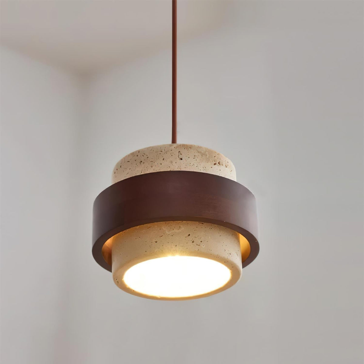 Pendant light with textured travertine shade and brown outer band