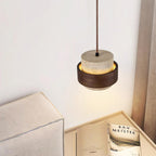 Pendant light with textured travertine shade and brown outer band