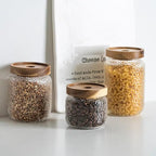 Clear hammered glass storage jar with dark timber lid