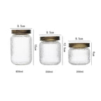Clear hammered glass storage jar with dark timber lid