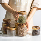 Clear hammered glass storage jar with dark timber lid