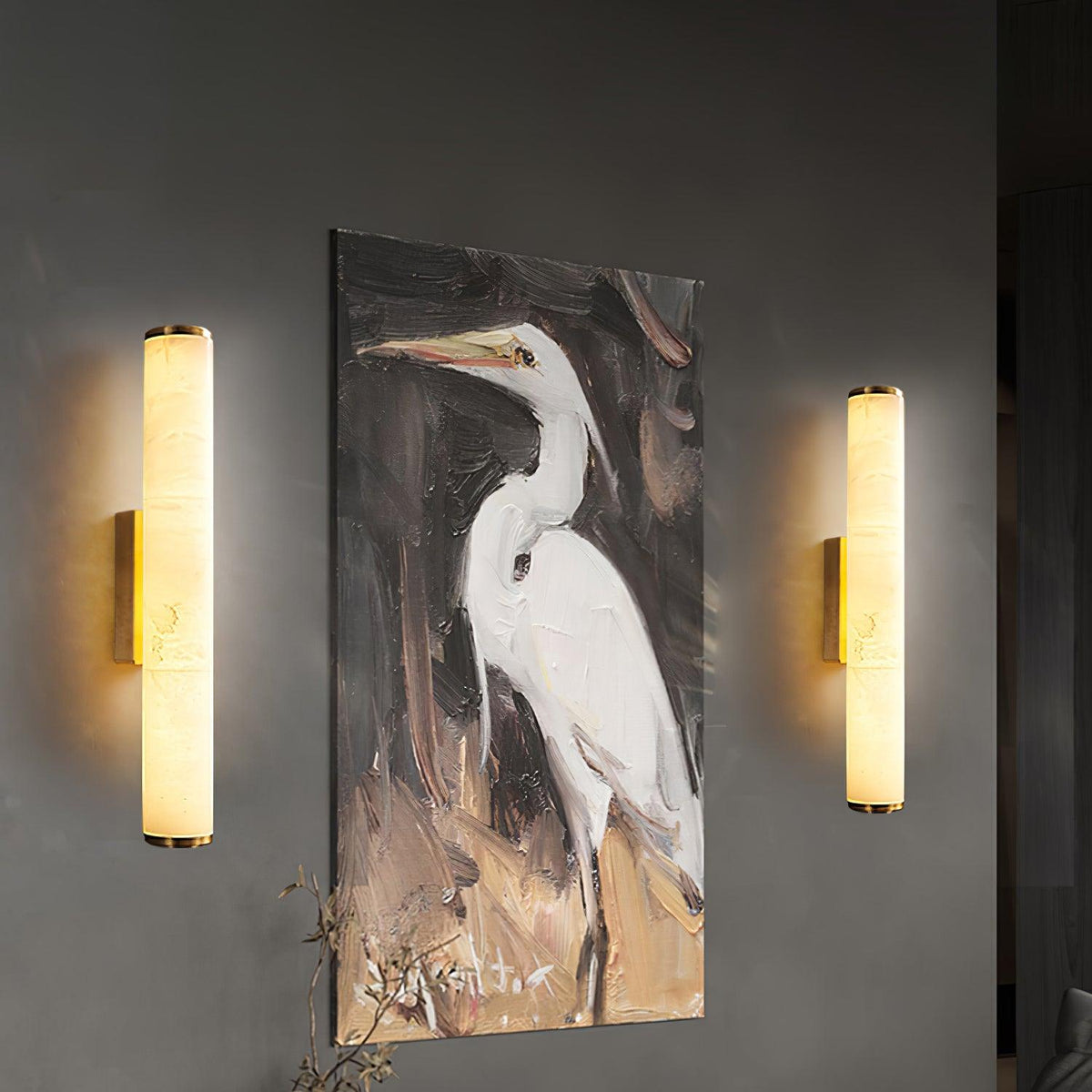Vertical alabaster column wall sconce emitting warm light