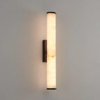 Vertical alabaster column wall sconce emitting warm light