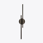 Linear metal wall sconce with round backplate