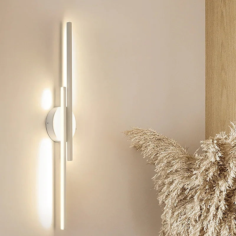 Linear metal wall sconce with round backplate