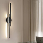 Linear metal wall sconce with round backplate