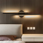 Linear metal wall sconce with round backplate