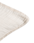 Cream muslin pillowcase with a softly crinkled texture and finished edges