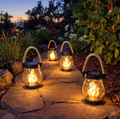 Solar garden lanterns with flame-effect lights and rope handles