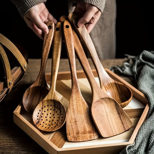 Five-piece brown wooden kitchen utensil set with spoons, slotted spoon and spatula