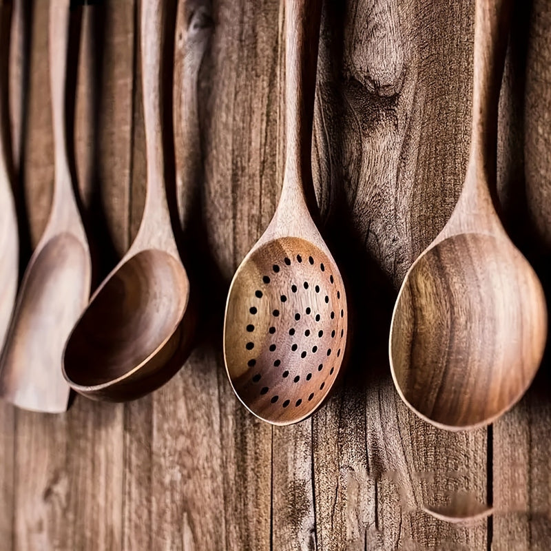 Five-piece brown wooden kitchen utensil set with spoons, slotted spoon and spatula