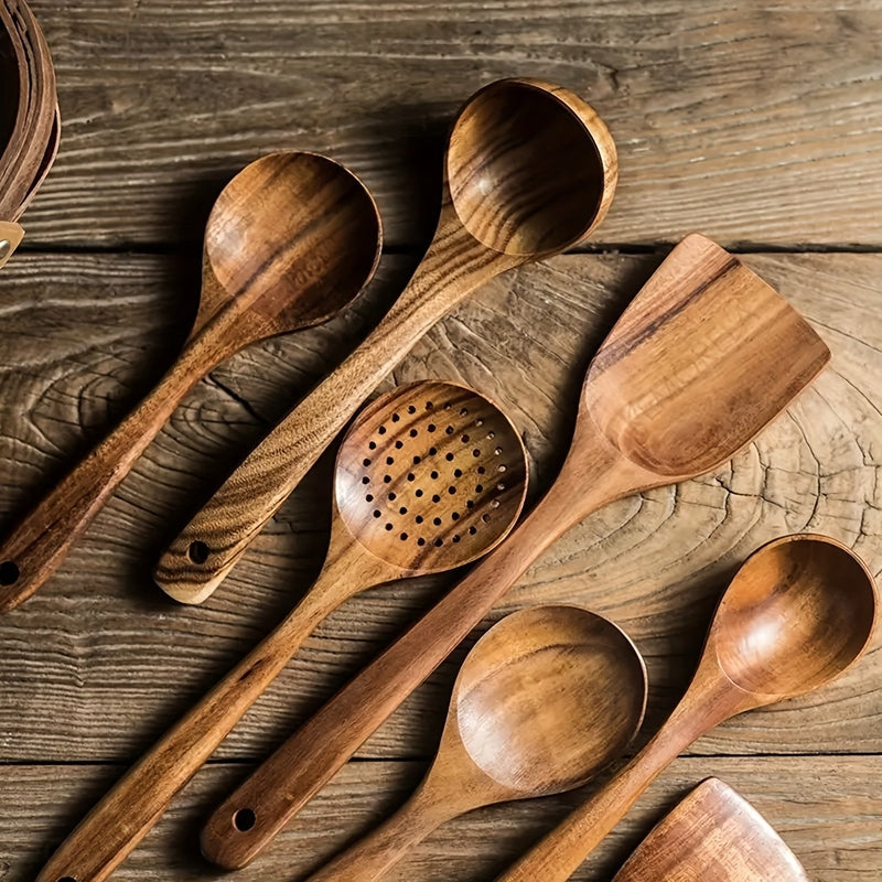 Five-piece brown wooden kitchen utensil set with spoons, slotted spoon and spatula