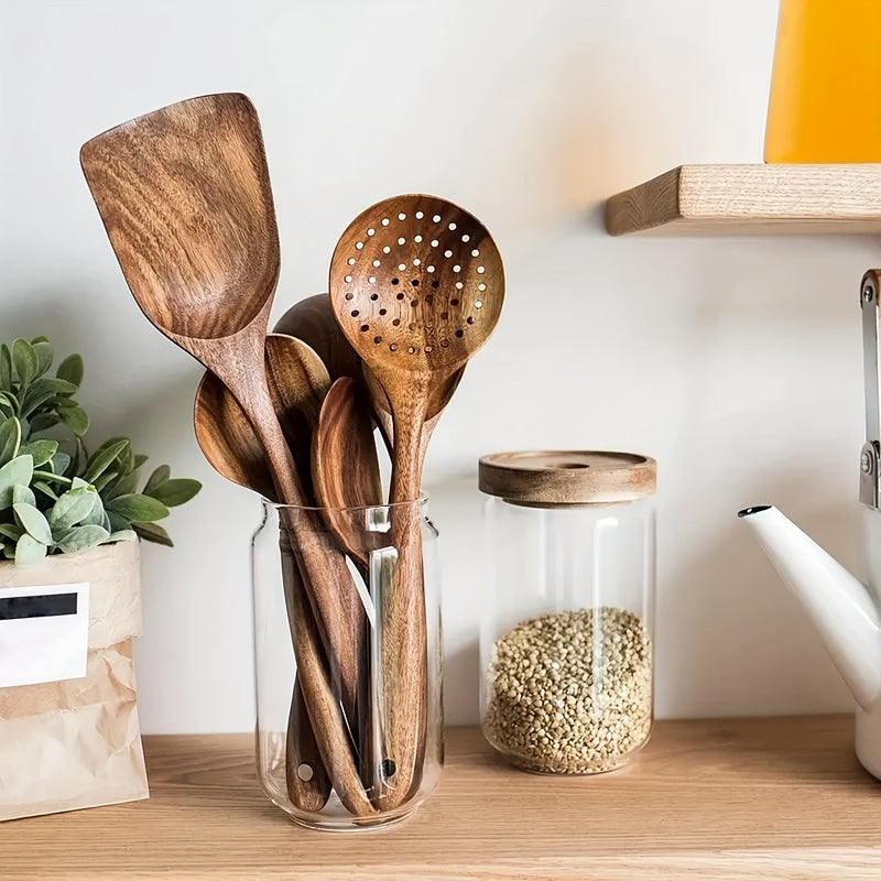 Five-piece brown wooden kitchen utensil set with spoons, slotted spoon and spatula