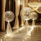 Clear LED balloons with warm white string lights along a garden path