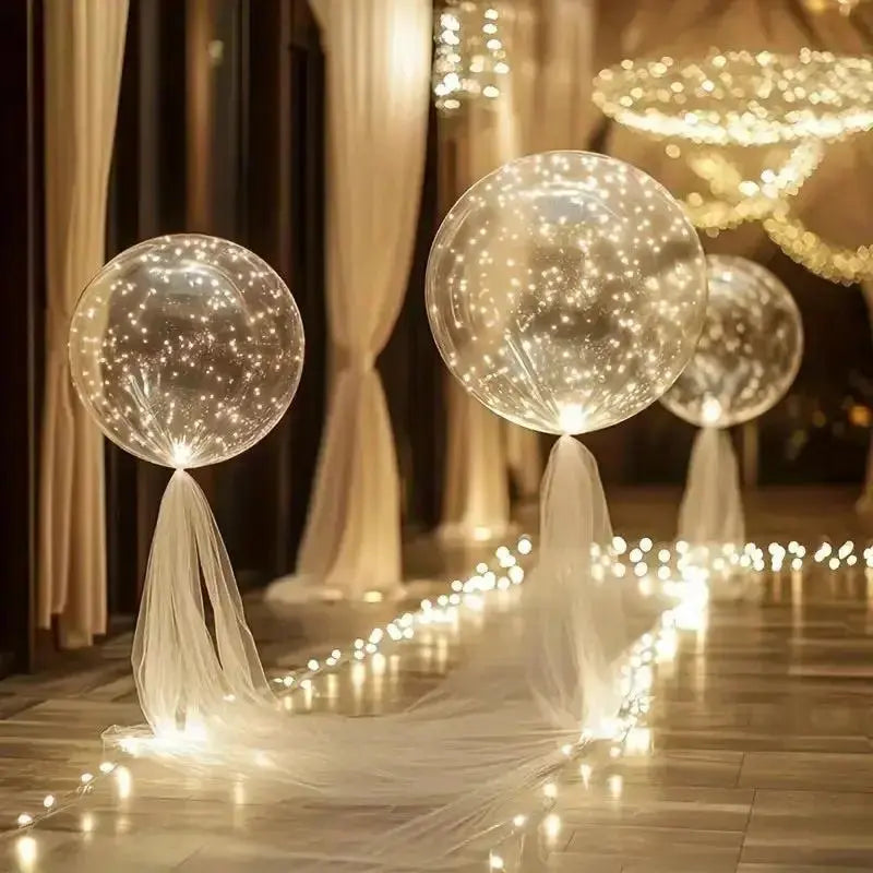 Clear LED balloons with warm white string lights along a garden path
