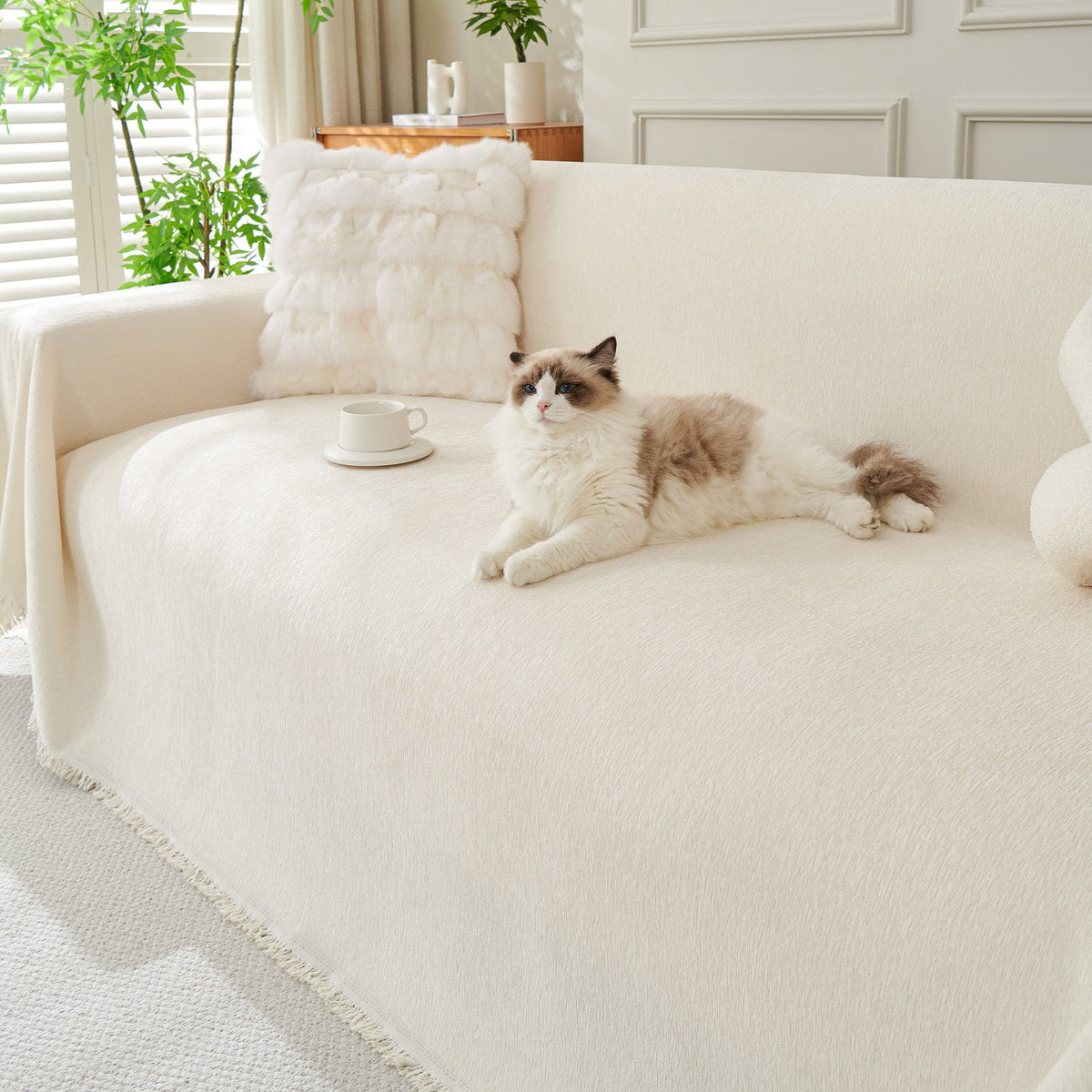 Draped sofa cover with fringed edges in a living room