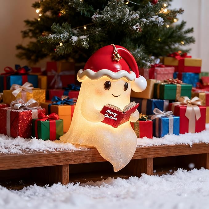 Illuminated beige Christmas ghost decoration wearing a red Santa hat and holding an open book