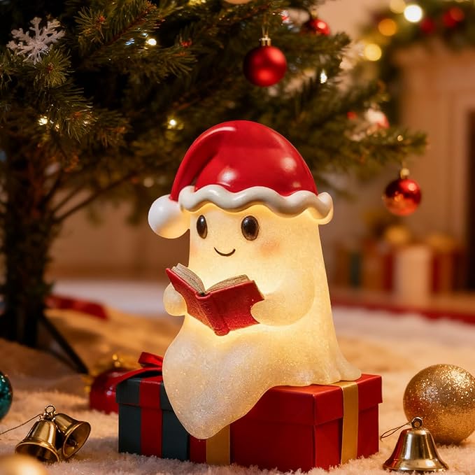 Illuminated beige Christmas ghost decoration wearing a red Santa hat and holding an open book