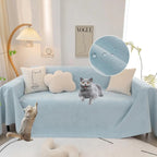 Light blue waterproof sofa cover draped over a sofa