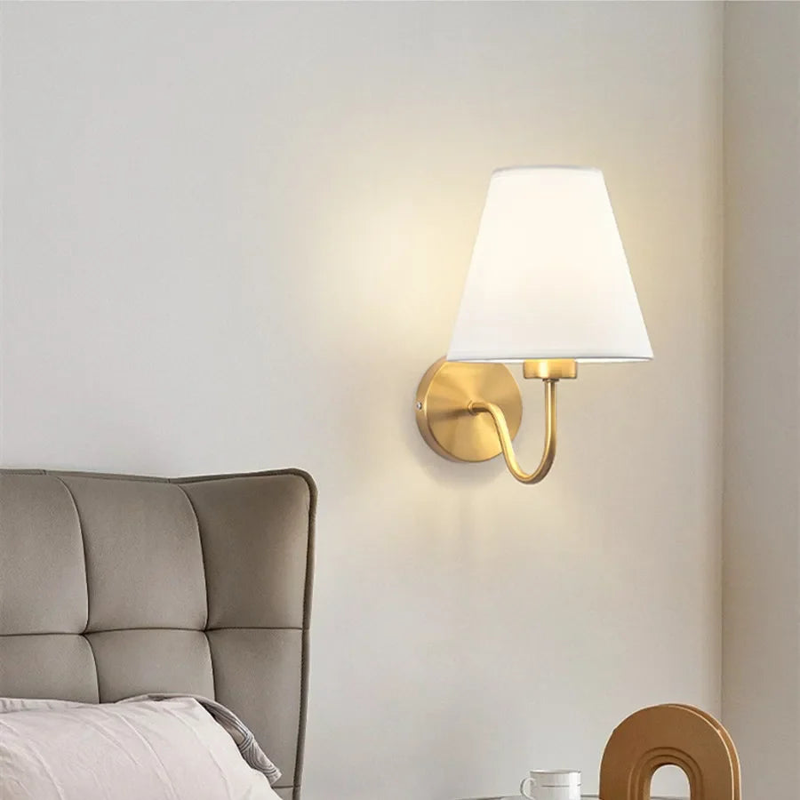 Wall lamp with tapered fabric shade and curved arm