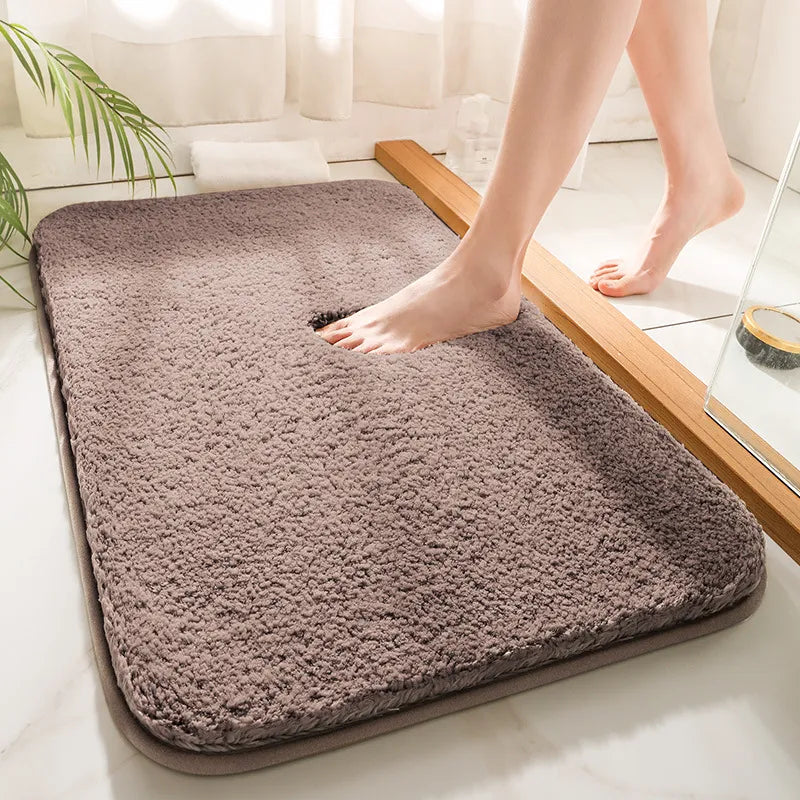 Thick soft-pile rectangular bathroom mat with rounded corners and a non-slip base