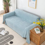 Light blue waterproof sofa cover draped over a sofa